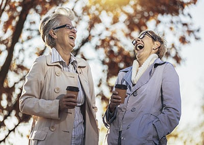 two senior women laughing