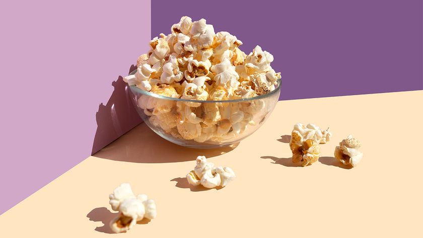 bowl of popcorn purple background abstract